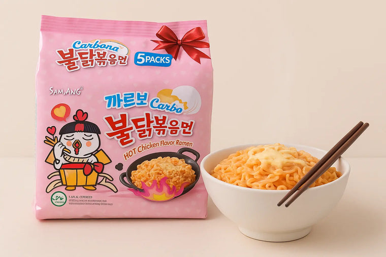 Samyang Carbonara Spicy Chicken Ramen 5-pack with pink packaging and cartoon chicken placed beside a steaming bowl of creamy ramen topped with cheese and chopsticks. Premium Seoul Oasis UAE lifestyle food image with realistic lighting.